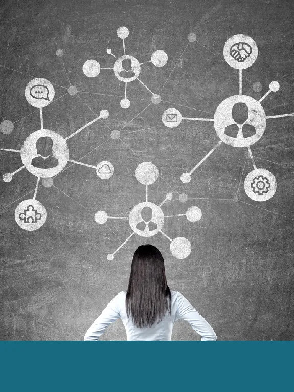 A person facing a wall-sized network diagram